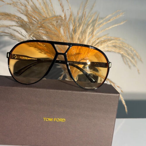 Tom Ford Xavier FT1060 aviator sunglasses in a black frame with yellow gradient lenses