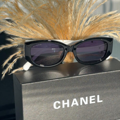 Chanel CH5524 sunglasses with a black frame and white arms